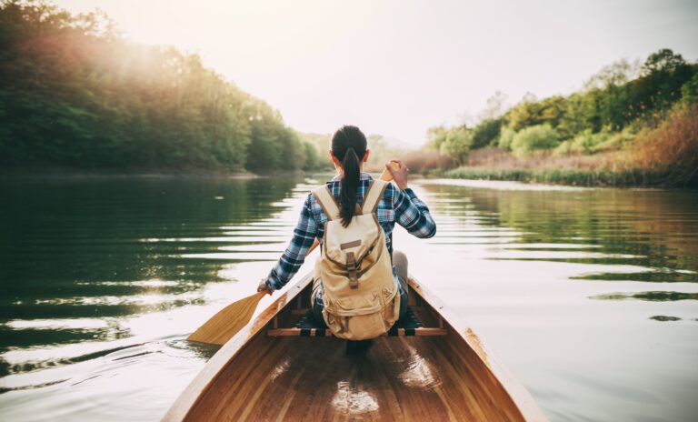 Peaceful woman canoeing on a lake